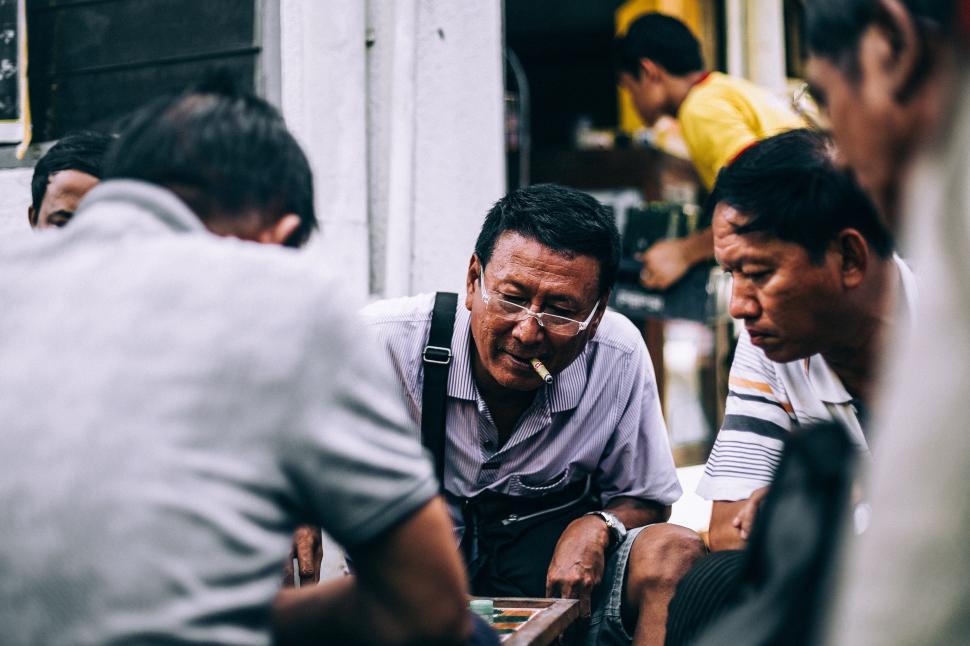 Free Image of Group of Men Sitting Next to Each Other 