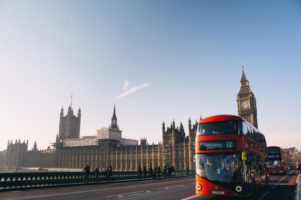 Free Image of Red Double Decker Bus Driving Down a Street 