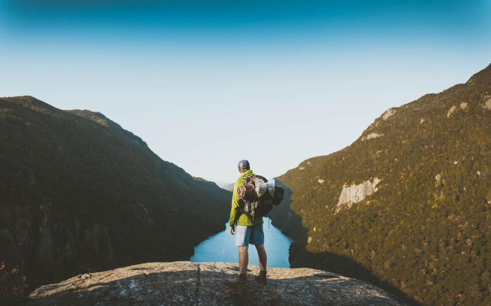 Free Image of Man Standing on Top of Mountain 