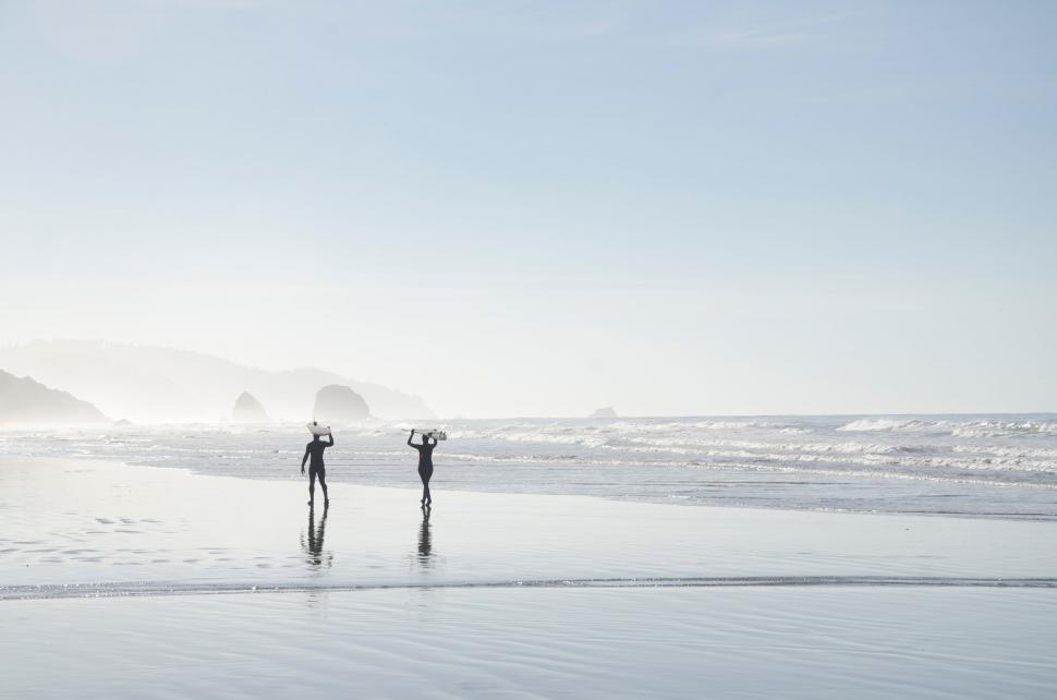 Free Image of Couple Standing on Top of Beach 
