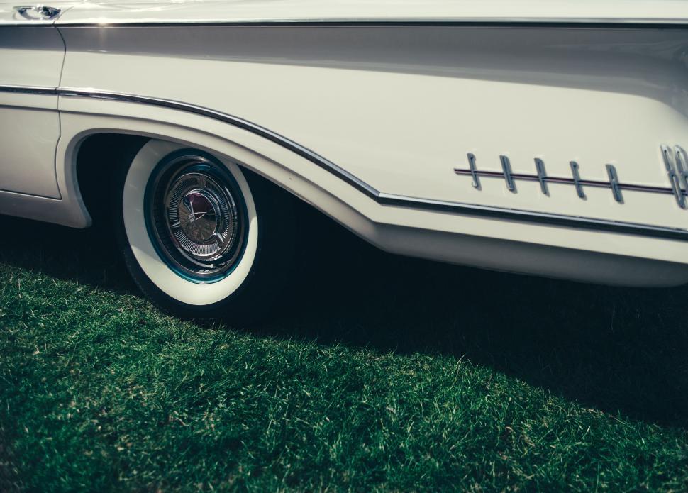 Free Image of White Car Parked on Lush Green Field 