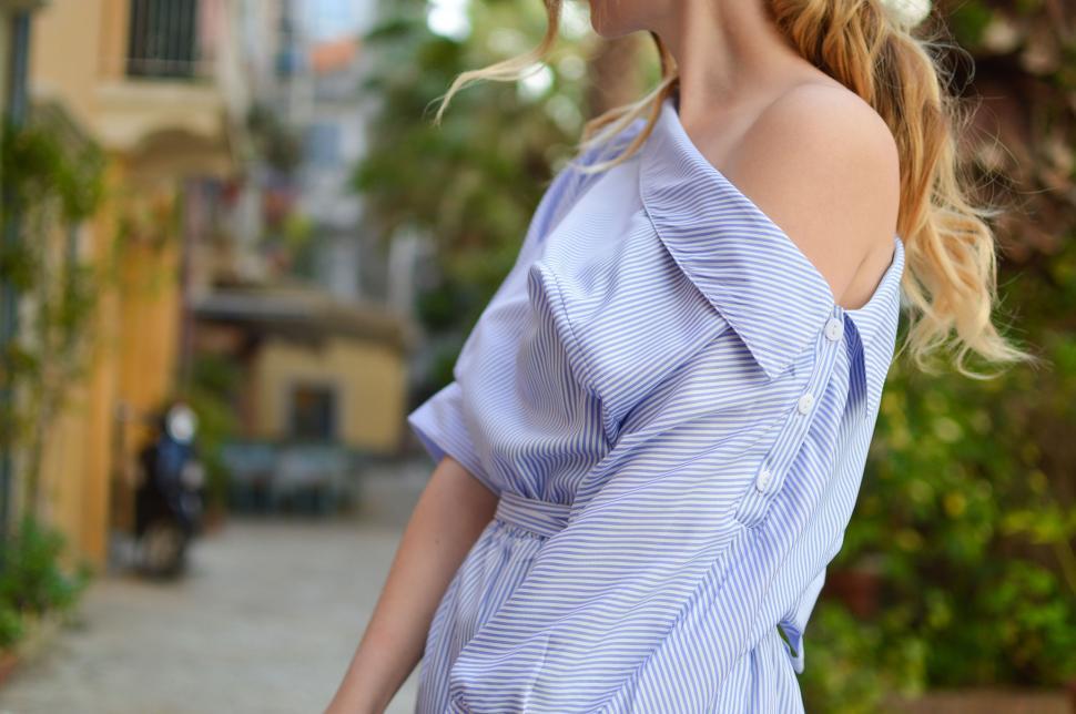 Free Image of Woman Walking Down a Street in a Dress 