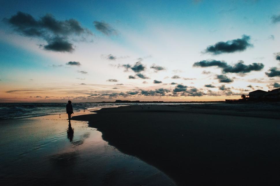 Free Image of Person Standing on Beach at Sunset 