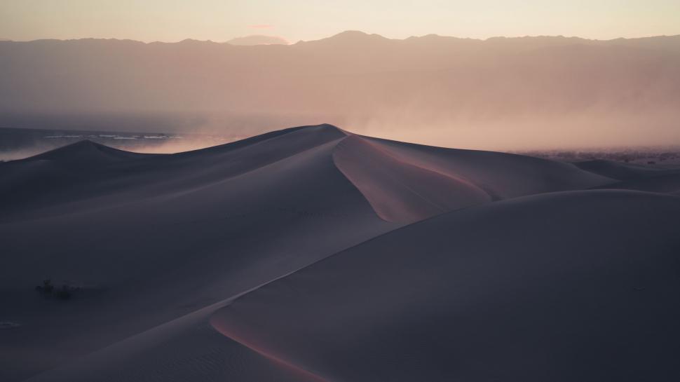 Free Image of Sun Shining Over Sand Dunes 