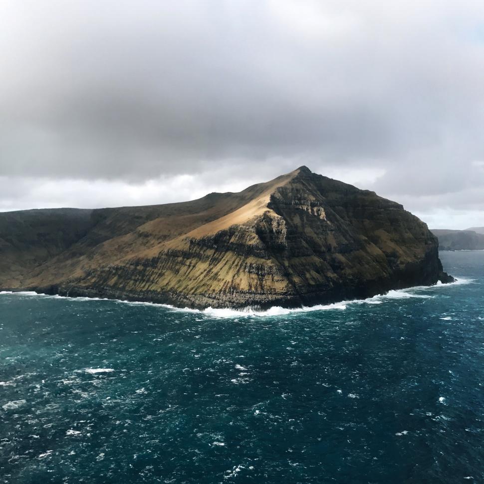 Free Image of Island Amidst Vast Ocean 