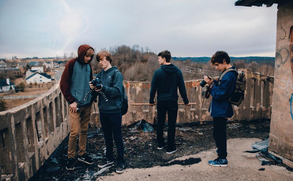 Free Image of Group of People Standing on Top of a Roof 