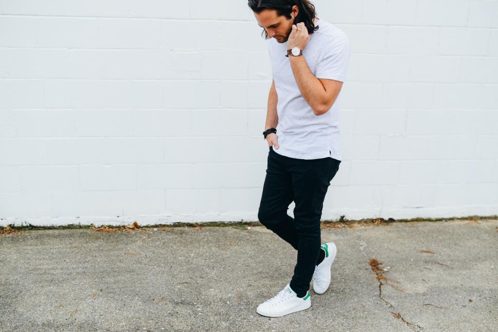 Free Image of Man in White Shirt and Black Pants Talking on Cell Phone 