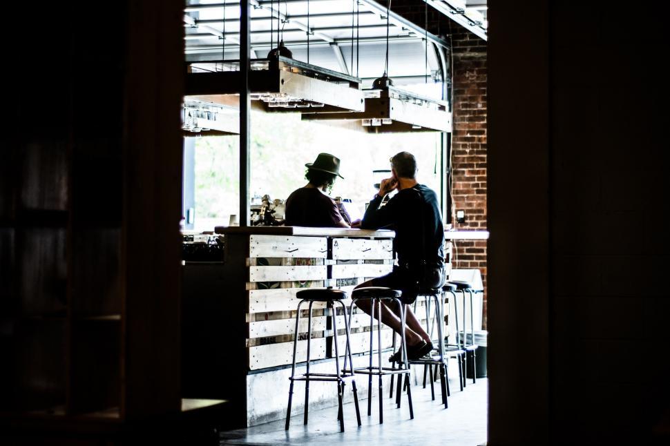 Free Image of Two Men Sitting at a Table 