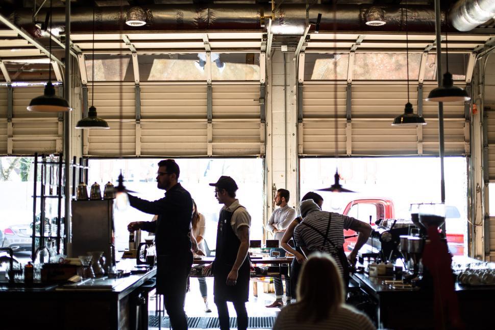 Free Image of Group of People Standing Around Kitchen 