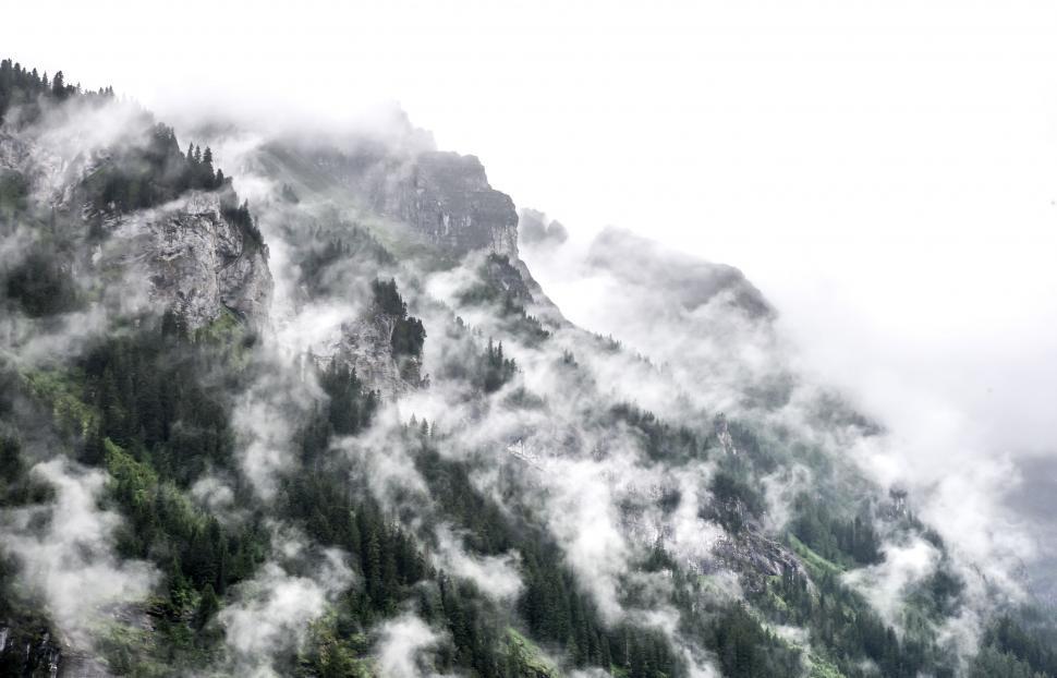 Free Image of Clouds Enveloping Mountain Peak 