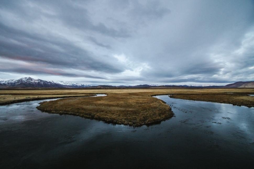 Free Image of River Running Through Wide Open Field 