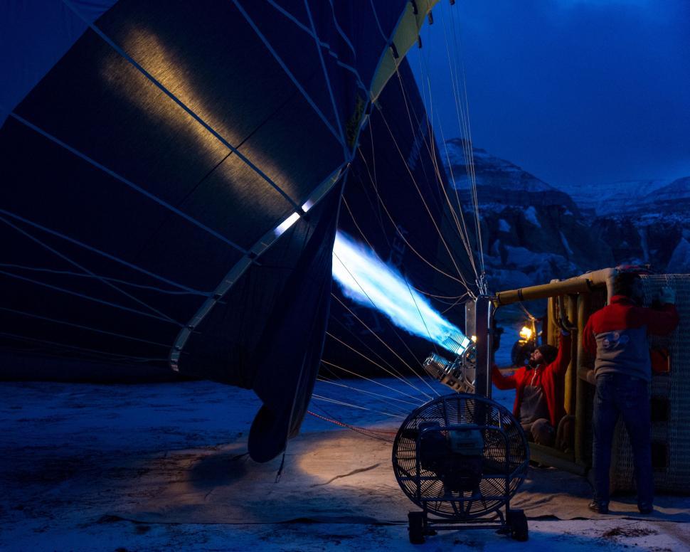 Free Image of Man Standing Next to Boat in Snow 