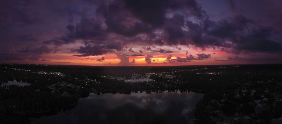 Free Image of Cloudy Sunset Over a Body of Water 