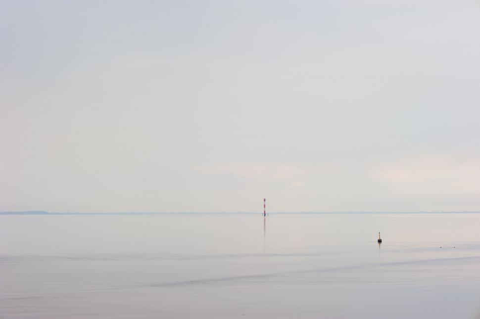 Free Image of Person Standing on Beach With Surfboard 