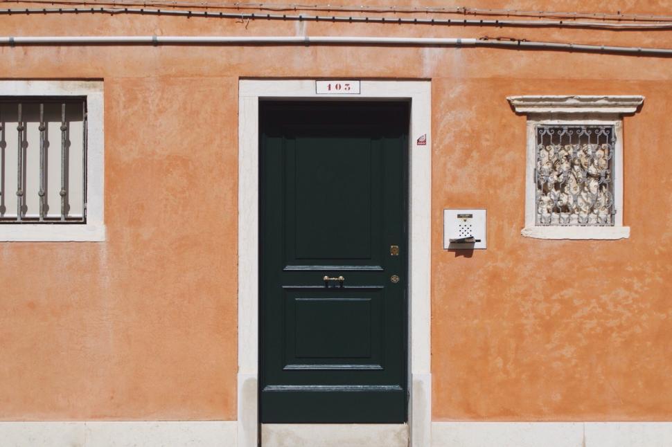 Free Image of Brown Building With Black Door and Window 