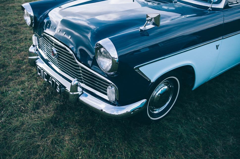 Free Image of Blue and White Car Parked on Grass Field 