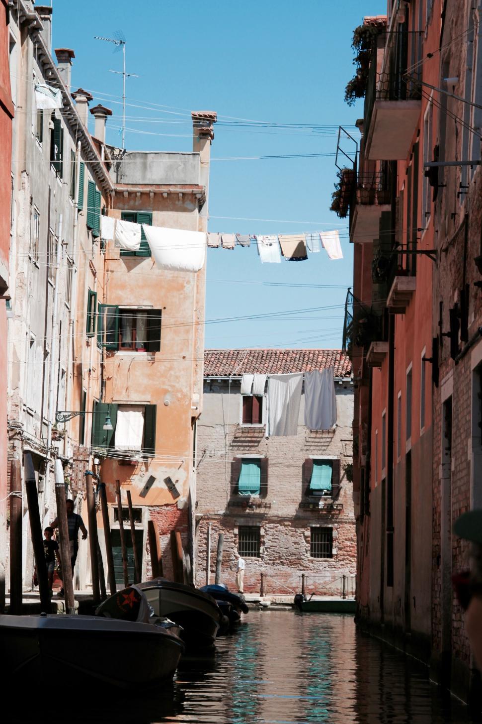 Free Image of Boats Sailing in Narrow Canal 