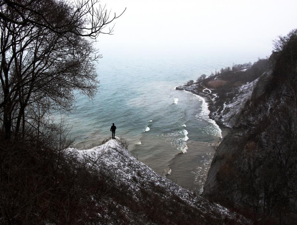 Free Image of Person Standing on Cliff Overlooking Ocean 