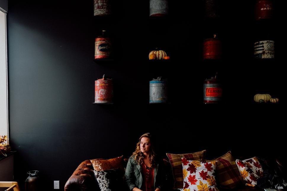 Free Image of Woman Sitting on a Couch in a Living Room 