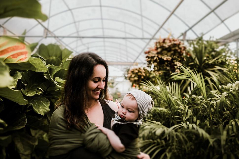 Free Image of Woman Holding Baby in Greenhouse 