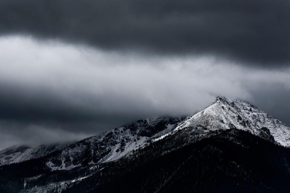 Free Image of Snow-Covered Mountain Beneath Cloudy Sky 