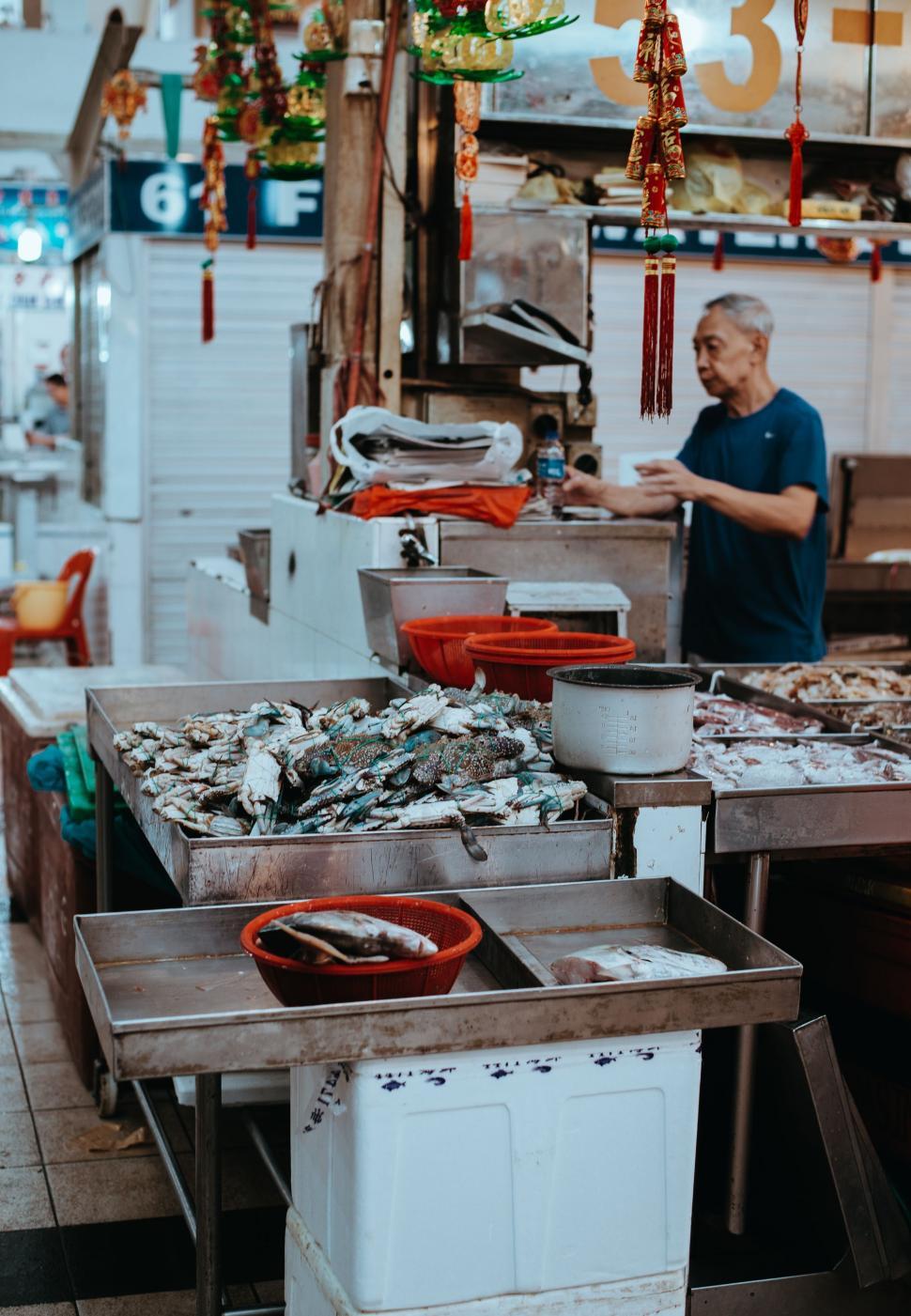 Free Image of Man Standing in Front of Table Filled With Food 