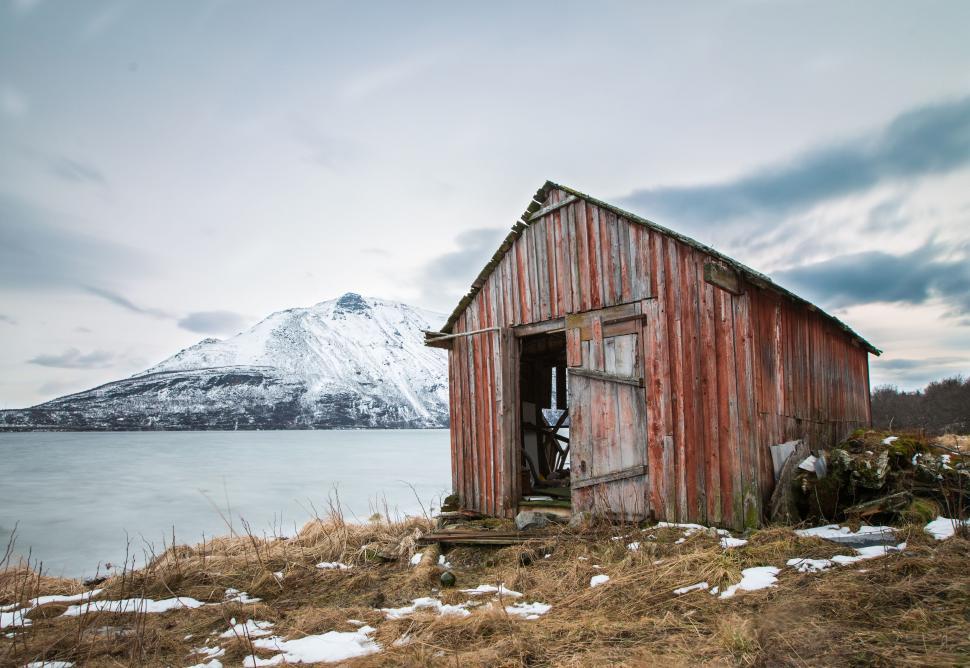 Free Image of Abandoned Outhouse by Lake Shore 