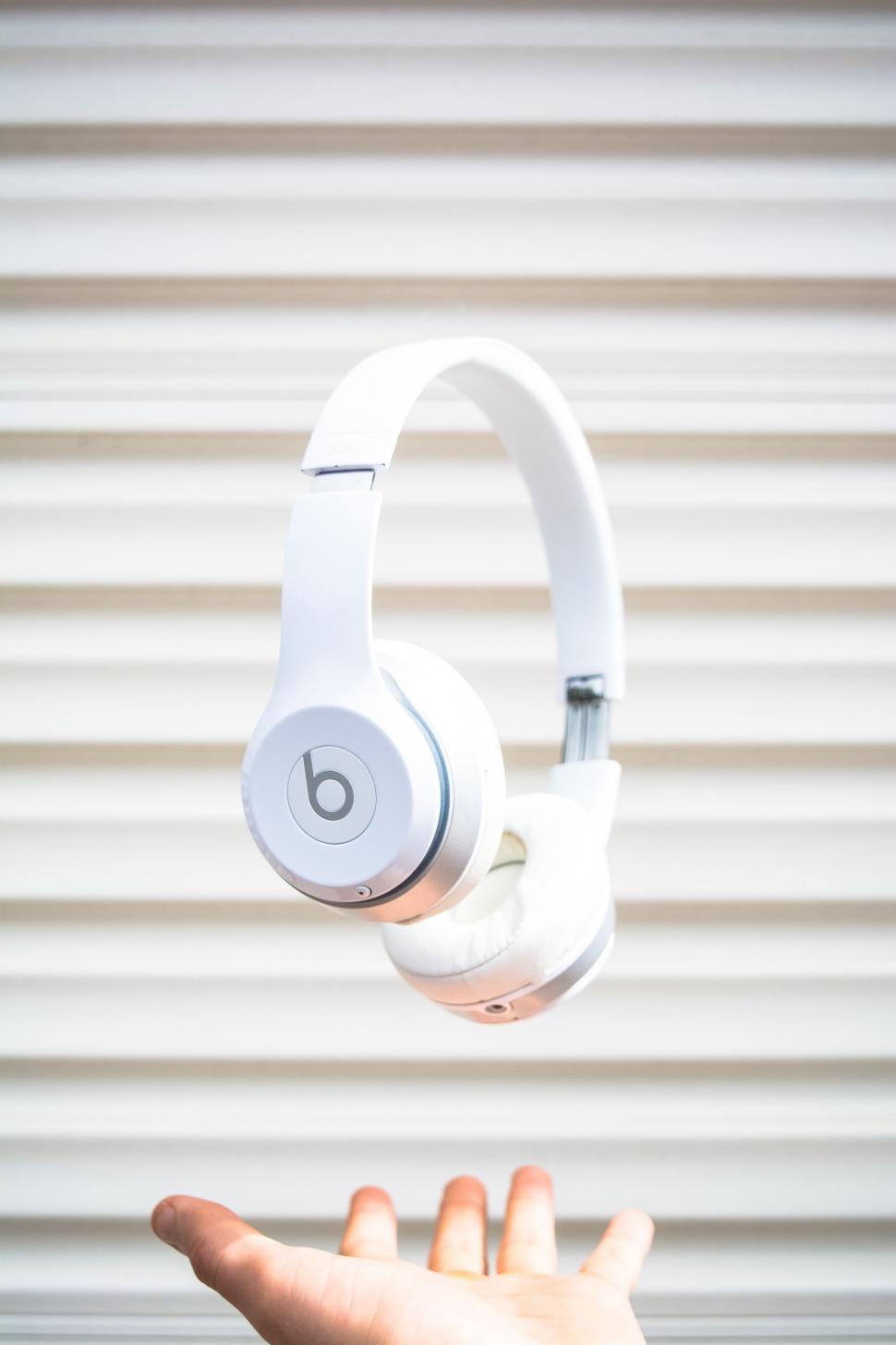 Free Image of Person Holding a Pair of Headphones 