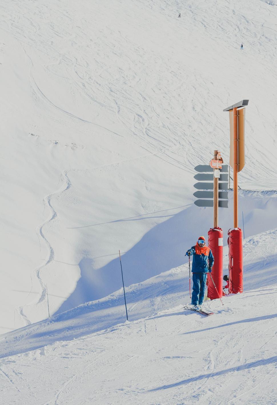 Free Image of Man Standing on Snow-Covered Slope 