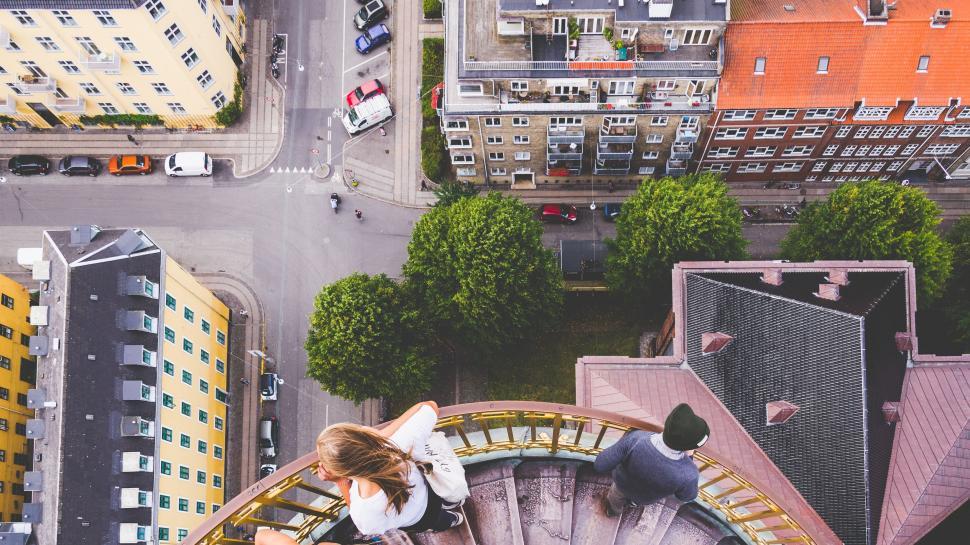 Free Image of Couple Standing on Top of Spiral Staircase 