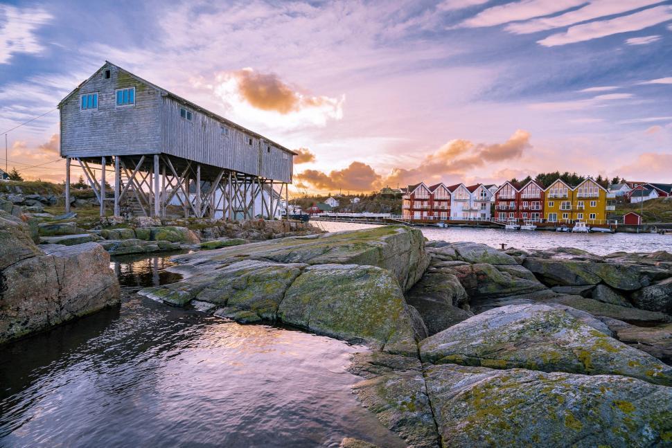 Free Image of House on Rocky Shore by Water 