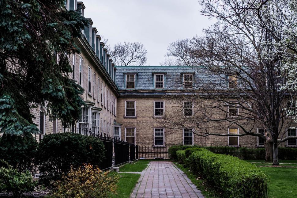 Free Image of Brick Walkway Leading to a Large Building 