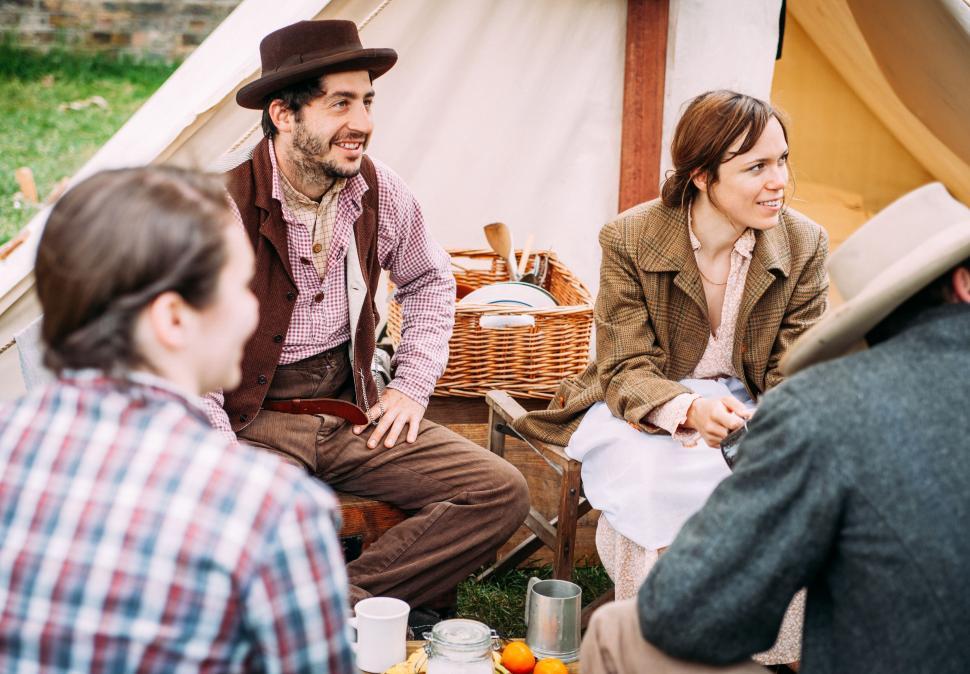 Free Image of Group of People Sitting Around a Tent 
