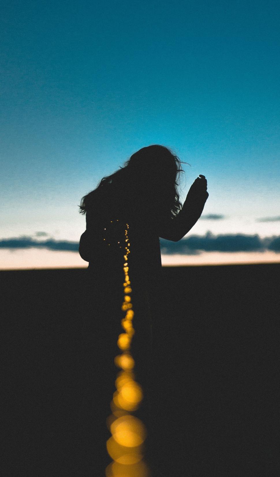 Free Image of Woman Standing in Middle of Road 