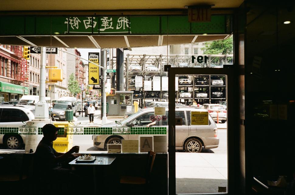 Free Image of Person Sitting at Table in Front of Window 