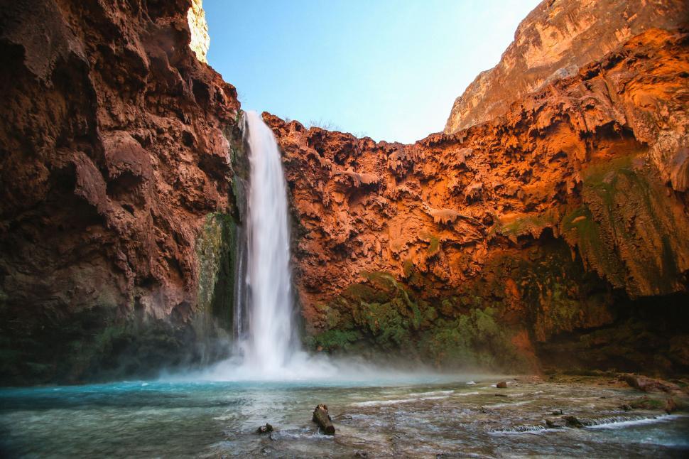 Free Image of Majestic Waterfall Cascading in Canyon 
