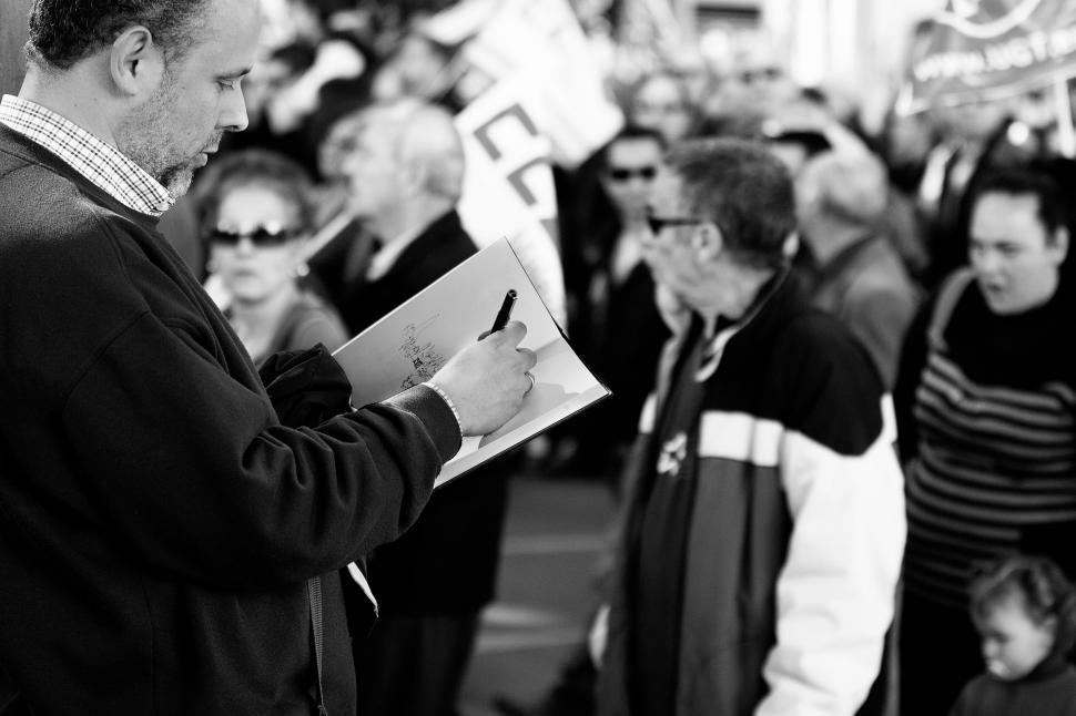 Free Image of Man Standing in Front of Crowd of People 