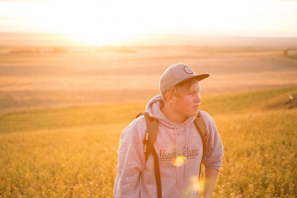 Free Image of Young Man Standing in Tall Grass Field 