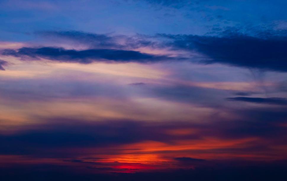 Free Image of Sun Setting in Sky Over Ocean 