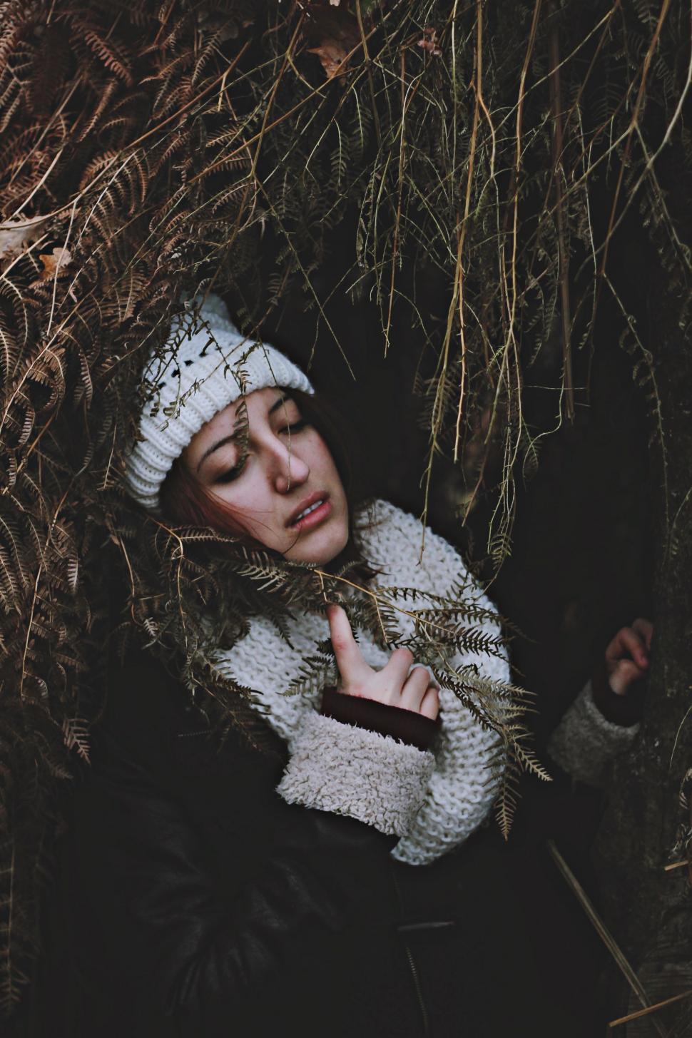Free Image of Woman in White Hat Hiding in Woods 