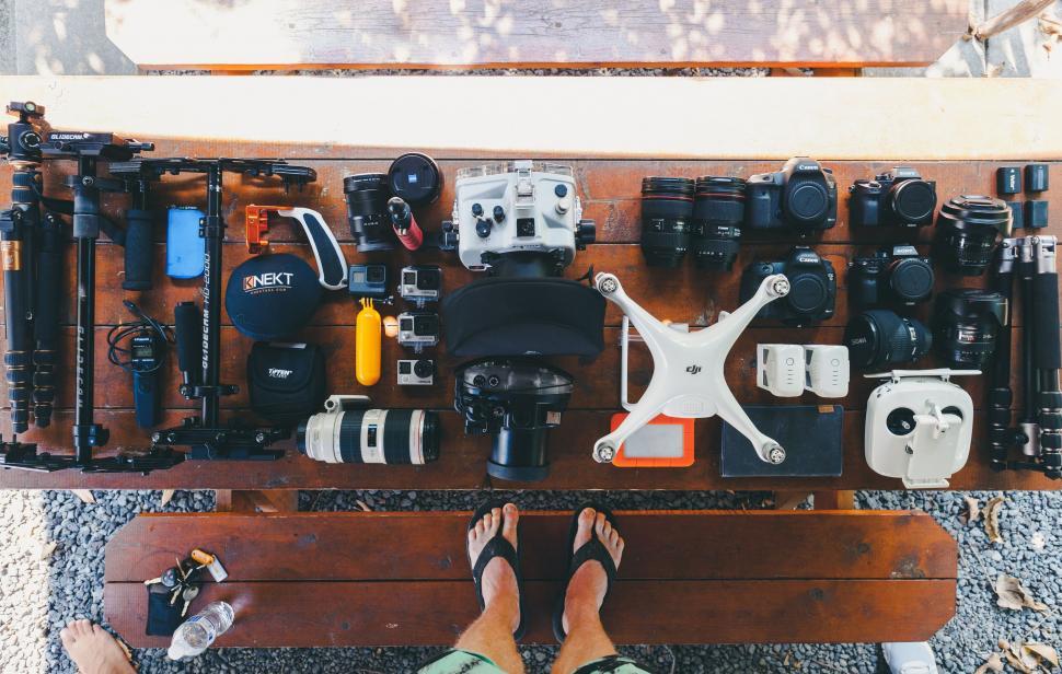 Free Image of Person Standing in Front of Display of Different Types of Cameras 
