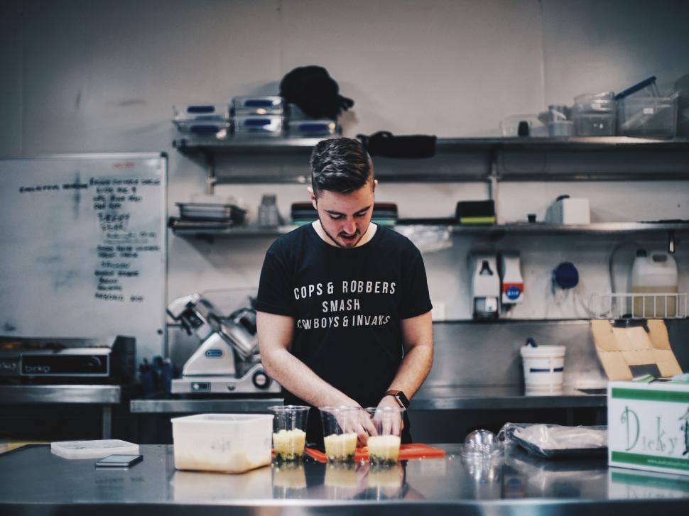 Free Image of Man Standing in Kitchen Preparing Food 