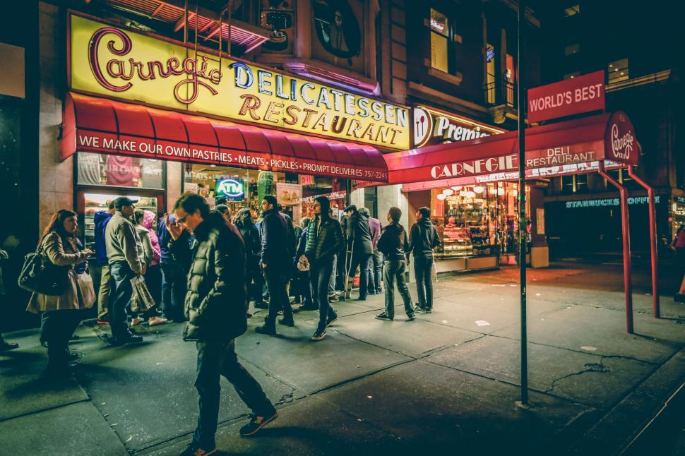 Free Image of Group of People Standing Outside of a Restaurant 