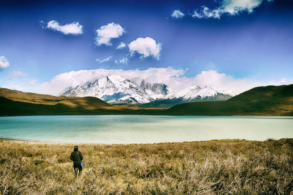 Free Image of Person Standing in Field With Mountain in Background 