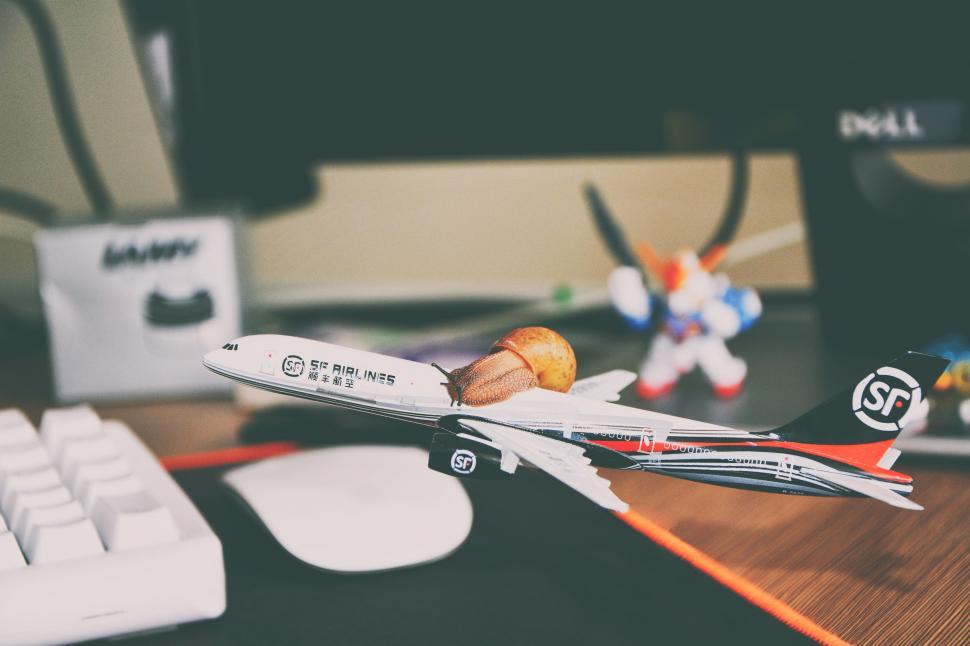 Free Image of Toy Airplane on Desk Next to Keyboard 