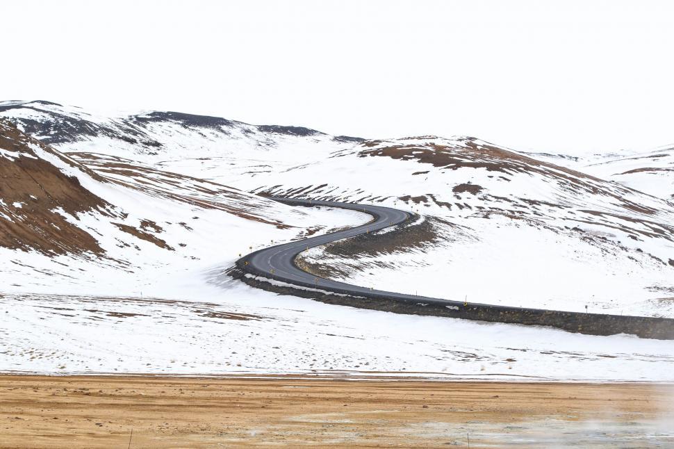Free Image of Truck Driving Down Snow Covered Road 