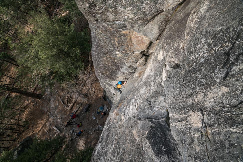 Free Image of Man Climbing Up Side of Mountain 