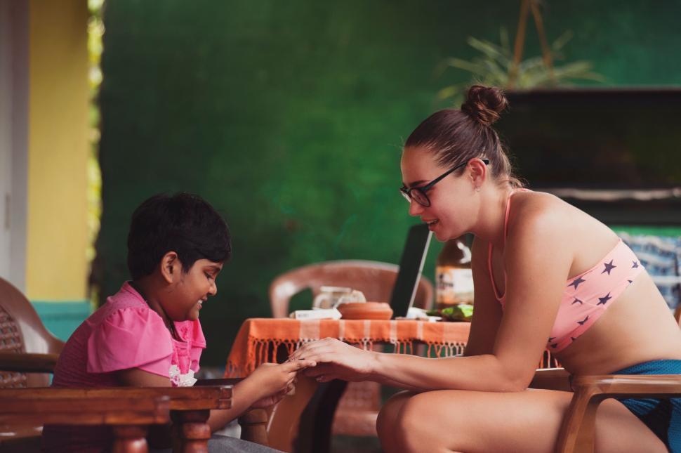 Free Image of Woman Sitting Next to Little Girl on Chair 