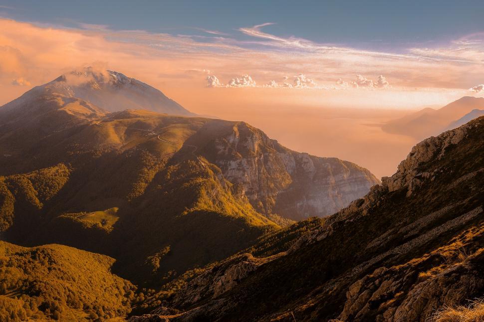 Free Image of Majestic Mountain Range Silhouetted Against Sunset Glow 