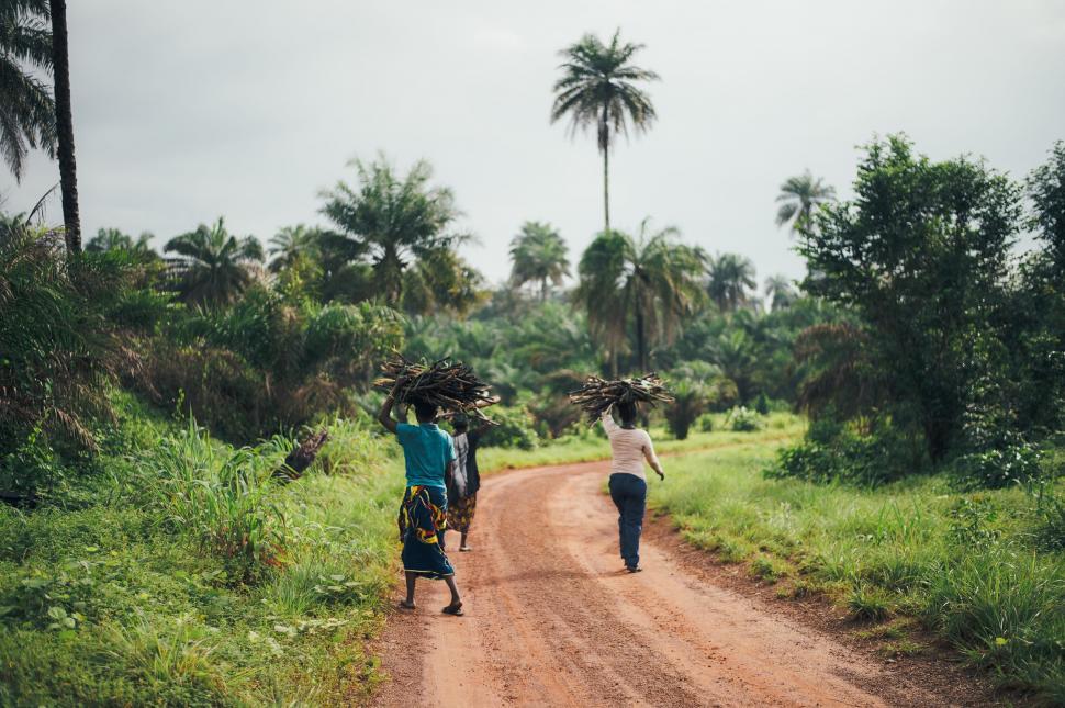 Free Image of Two People Walking Down a Dirt Road 